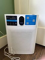 Front view showing Morento branding, perforated grille, control panel, and attached cord