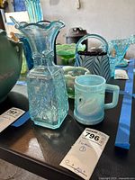 Vase, mug and surrounding glass items with lot tag visible
