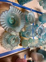 Top view of all blue opalescent art glass pieces on table