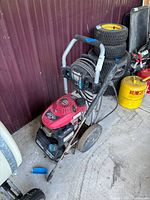 Full view of Homelite pressure washer showing frame, engine, hose and wand