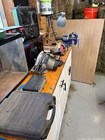 Overview of vise, saws, cases on workbench