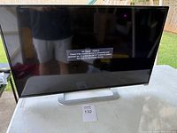 Front view of Vizio TV powered on displaying 'No Signal' message