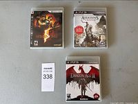 Resident Evil, Assassin's Creed III and Dragon Age II PS3 game cases