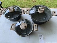 Top view of the three Carote casseroles with lids showing size comparison and handles