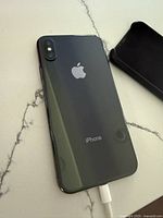 Rear view of black/space-gray iPhone showing dual vertical camera and Apple logo