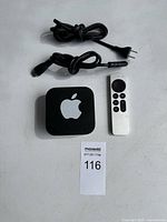 Apple TV unit, remote, two cables overview