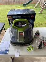 Front view of Little Green ProHeat cleaner, hose, manual, formula bottle, sealed tool, original box