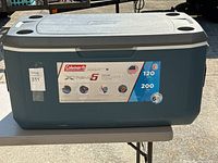Front view of Coleman Xtreme 5 120-quart cooler showing label, cup holders, and size