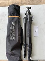 Tripod folded next to branded carry bag