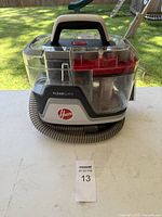 Front view of Hoover CleanSlate cleaner showing body, handle, hose and tank