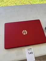 Closed red HP laptop top view