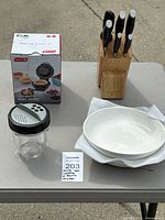 Full lot showing knife block with knives, boxed waffle maker, bowls and shake cup