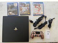 Console, controller, cables, three PS4 game cases