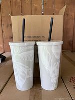 Two Starbucks Reserve tumblers with straws