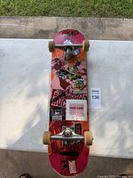 Top view of complete skateboard showing deck graphics, trucks, wheels