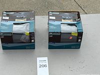 two boxed Veranda solar post cap lights on table