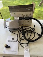 Main unit with hose, brush, manual and box displayed on table