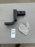 Black steel trailer hitch ball mount with pin and clip on table