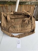 Front view showing MOLLE webbing, shoulder strap, hook-and-loop panel