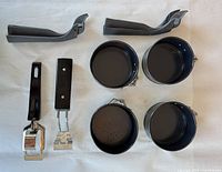 top view of four pans and four handles