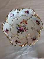 Overhead view showing floral decoration and scalloped gilt rim