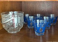 Set showing six blue overlay glasses and clear ice bucket