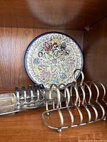 Tray with fixed toast rack and two glass dishes on wooden shelf