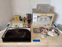 Overview of lot showing jewelry box, perfumes, masks, hairpiece