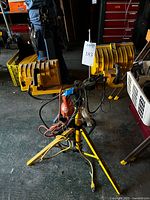 Yellow twin-head tripod work light with cords visible