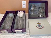 Two boxed decanters and two boxed snifters showing pattern, stoppers, and original Courtenay packaging