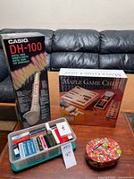 Overall lot showing DH-100 box, Maple Game Chest box, tub of card decks, fabric bean bags