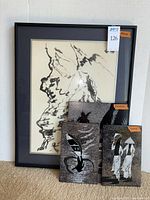 Front view of framed mountain drawing and three panels