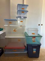 Stack of assorted plastic bins showing size variety and lids