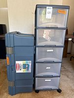 Front view of Rubbermaid hinged tote and five-drawer rolling cart side by side
