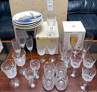 Overall lot showing Waterford crystal glasses, additional glassware and stacked plates