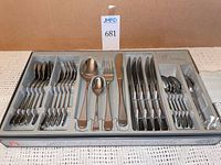 Full boxed flatware set showing all pieces arranged in tray