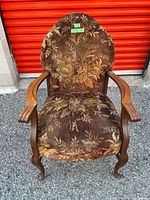 Front view of armchair showing upholstery pattern and wood frame