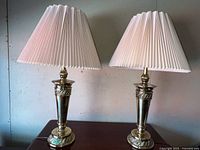 Front view showing both matching brass lamps with shades