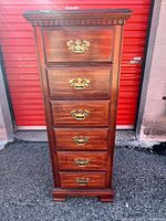 Front view showing six drawers, brass hardware, full height