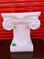 Front view of white Ionic pedestal stand