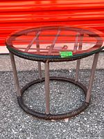 Side view of round table with glass top showing frame and wicker wrap
