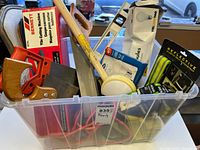 Bin containing assorted hand tools and accessories