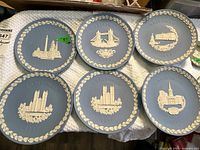 Six blue 8" Christmas plates with white relief