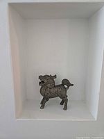 Qilin brass figurine front view in display niche