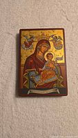 Front view of Byzantine-style icon plaque showing Virgin Mary with Child, gold leaf background, vibrant colors