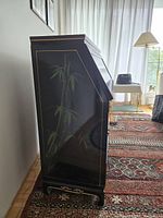 Left side view showing bamboo motif, lacquer finish and gold borders