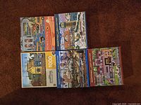 All five puzzle boxes arranged to show fronts and themes