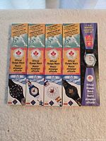 Front view showing five McDonald's Official Olympic wristwatches in original packaging—four boxed, one blister card