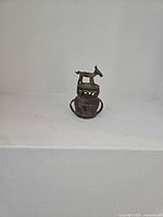 Donkey on vessel brass figurine