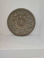 Round brass plate with lotus rosette design and silver-tone inlay